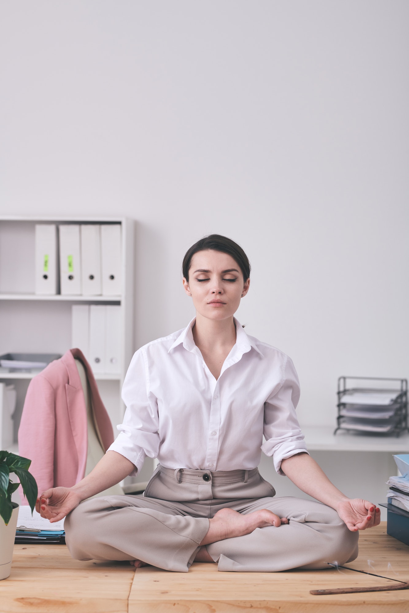 Calm businesswoman meditating in office